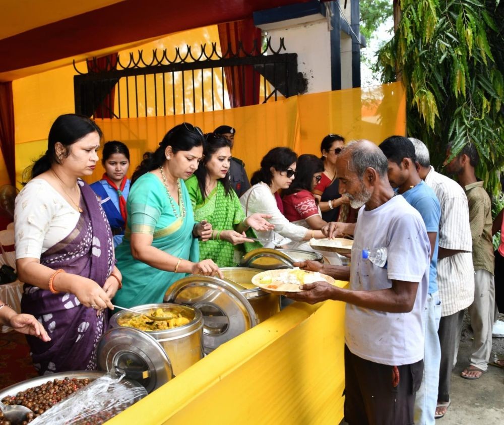 Members of the Northeast Frontier Railway Women's Welfare Organization serve food to devotees at Kamakhya Railway Station during the Ambubachi Mela as part of NFR's passenger assistance and welfare initiatives.